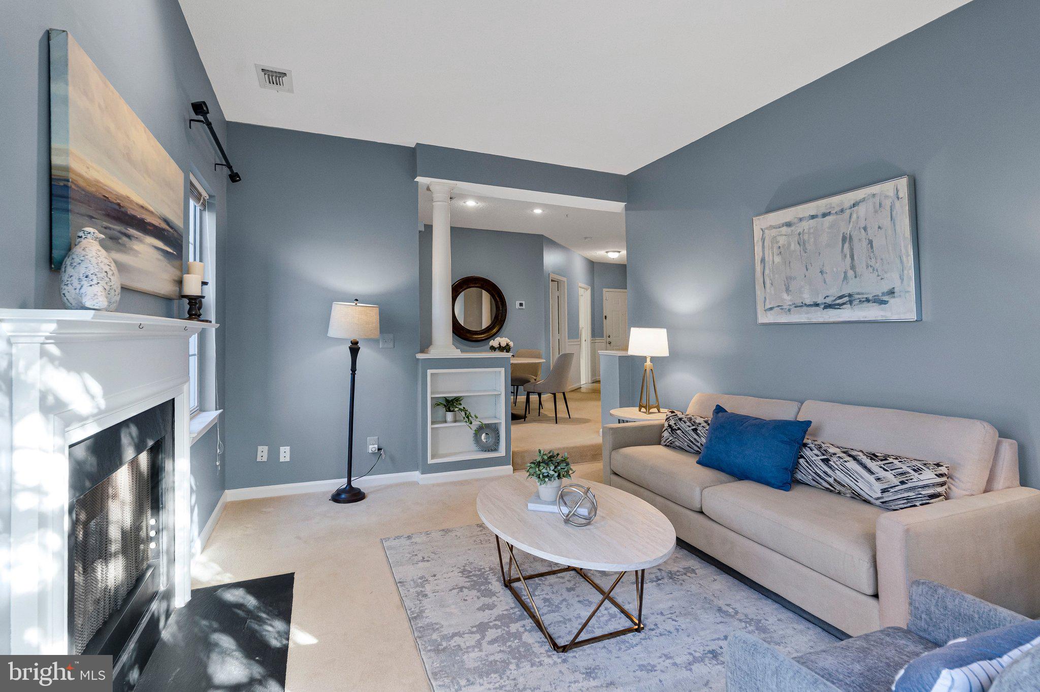 1720 Lake Shore Crest Drive, Unit 26 Reston, VA 20190 - Photo 4 of 38 a living room with furniture and a fireplace