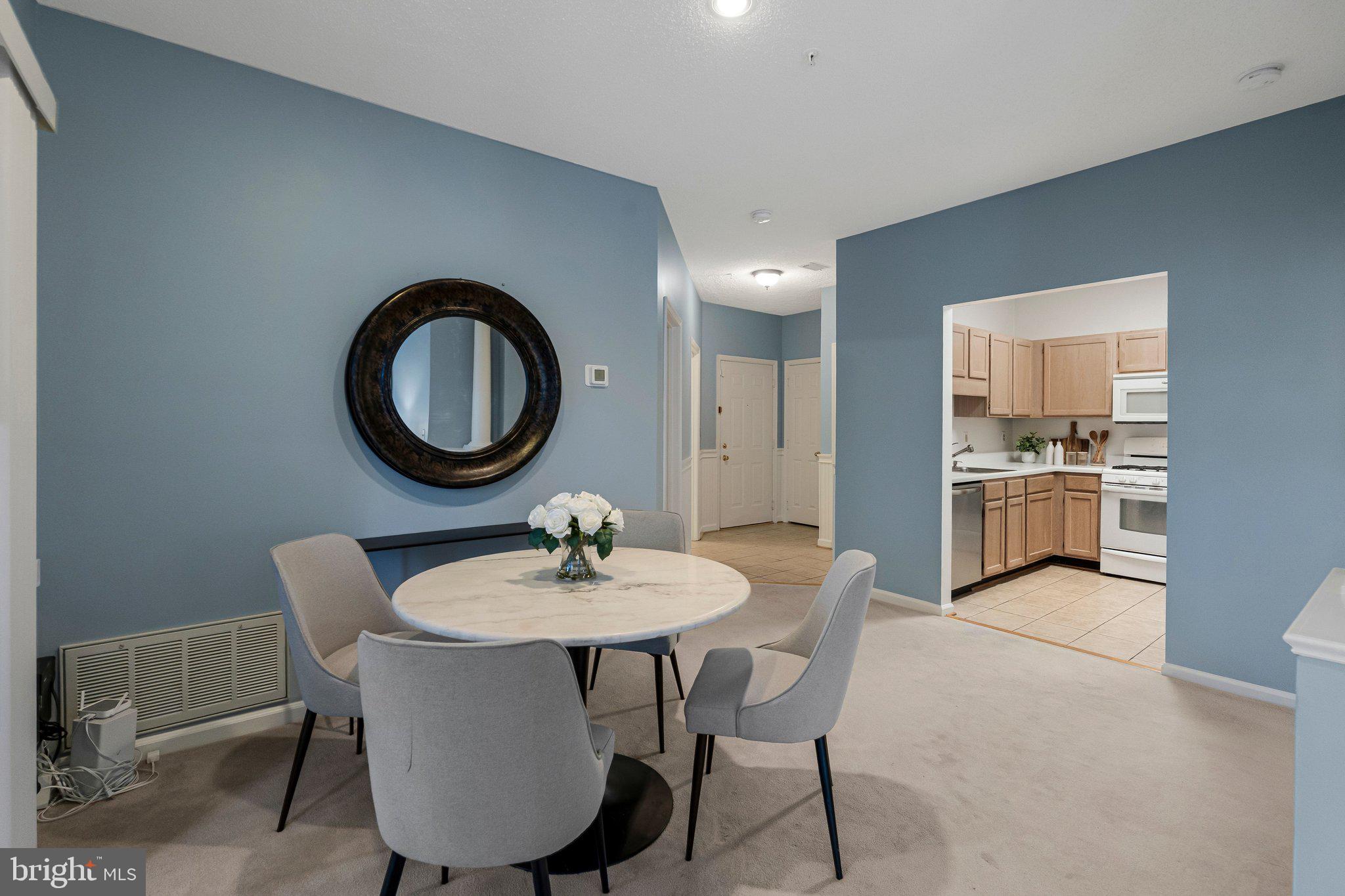 1720 Lake Shore Crest Drive, Unit 26 Reston, VA 20190 - Photo 8 of 38 a view of a dining room with furniture and a mirror