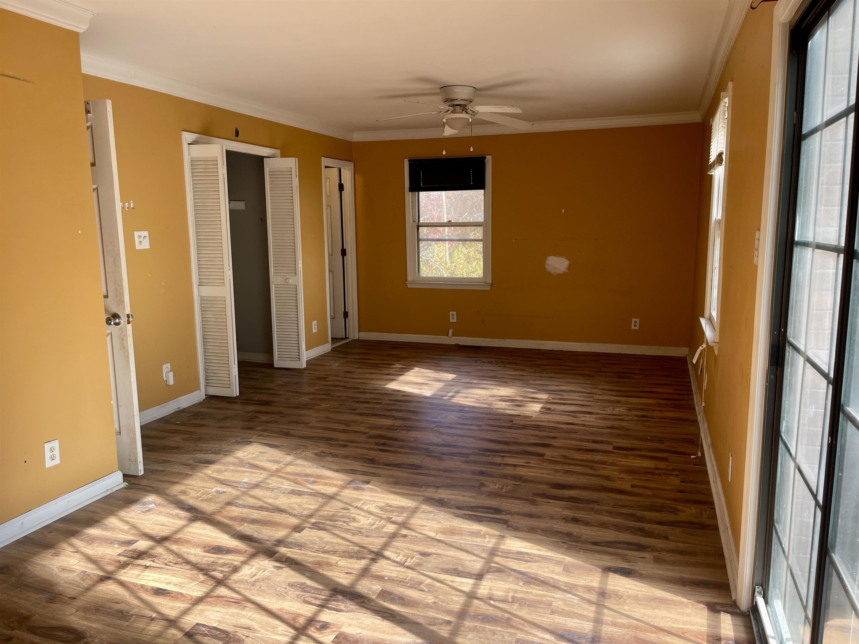 5017 Robinwood Road Durham, NC 27713 - Photo 12 of 31 a view of an empty room with window and wooden floor