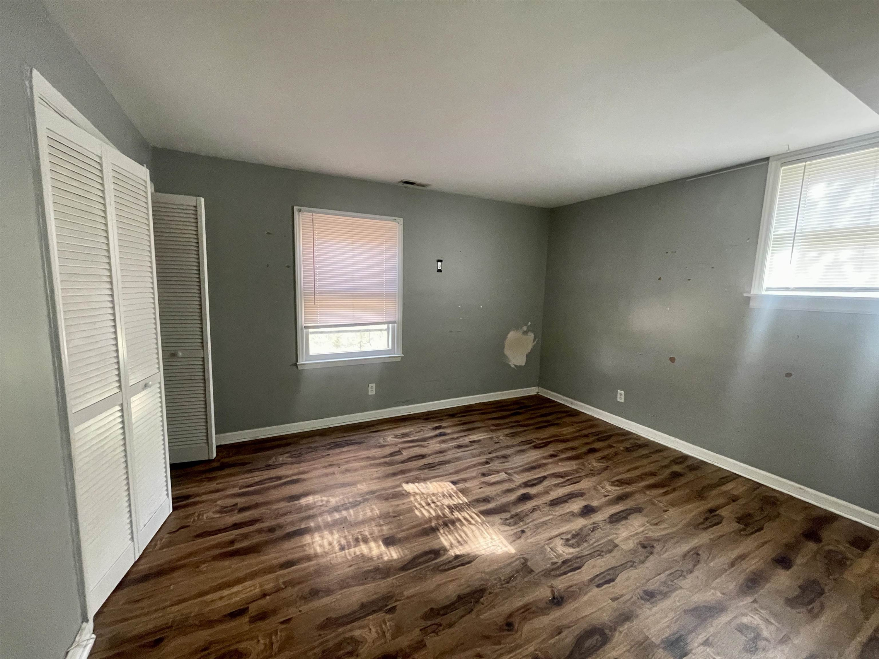 5017 Robinwood Road Durham, NC 27713 - Photo 16 of 31 an empty room with wooden floor and windows
