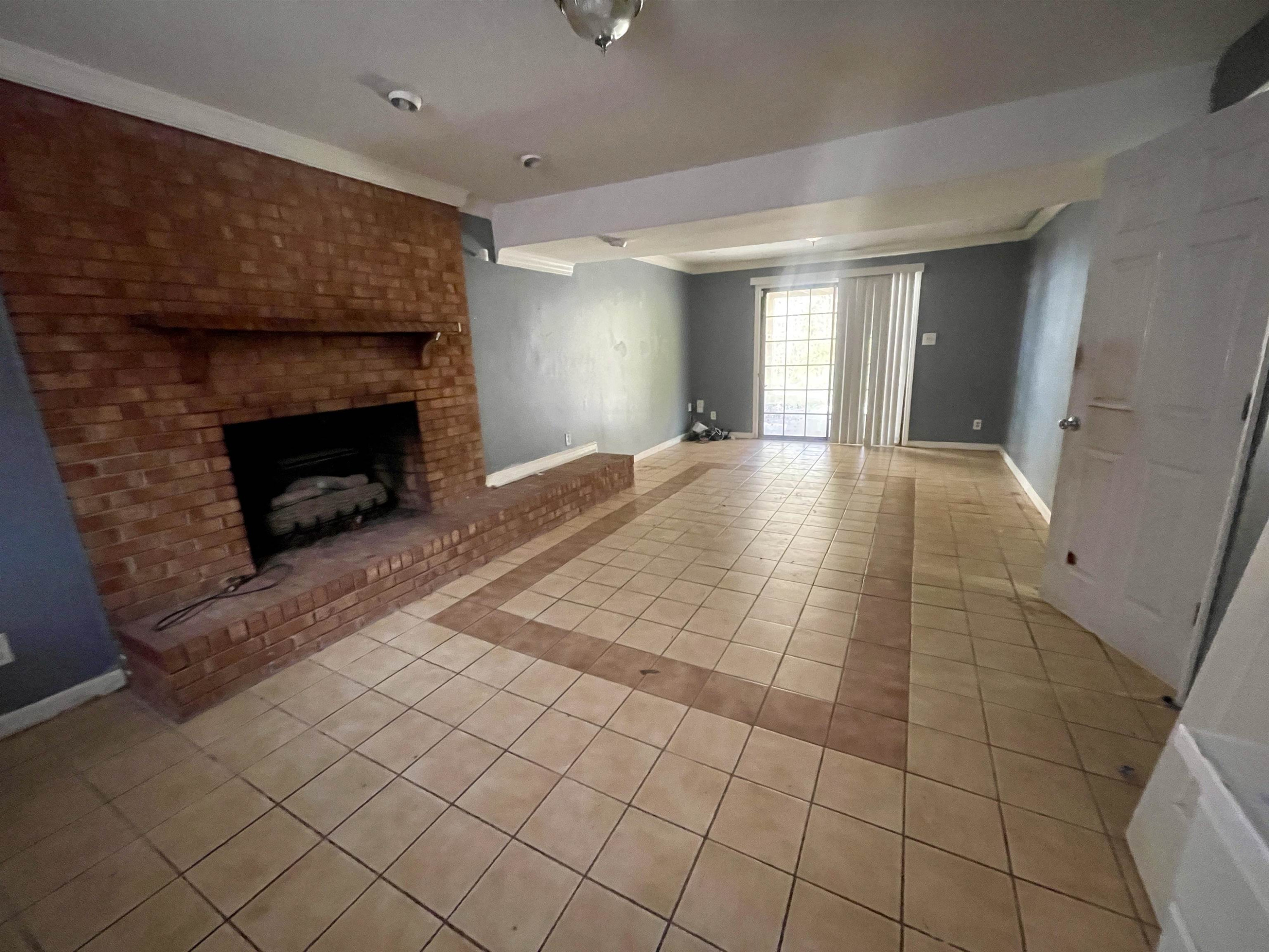 5017 Robinwood Road Durham, NC 27713 - Photo 20 of 31 a view of empty room with wooden floor and fireplace