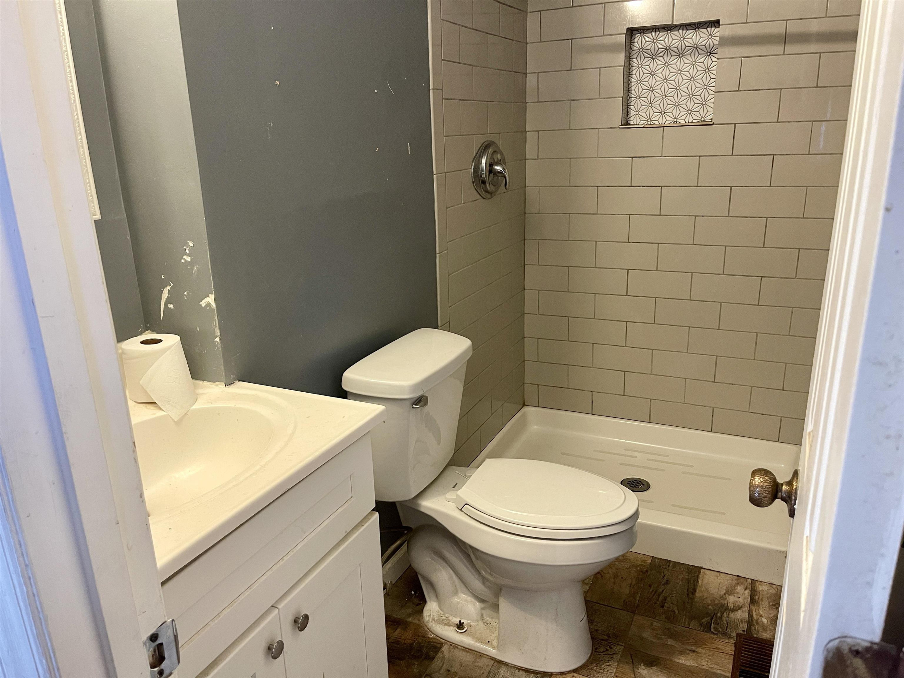 5017 Robinwood Road Durham, NC 27713 - Photo 10 of 31 a white toilet sitting next to a bath tub and a shower