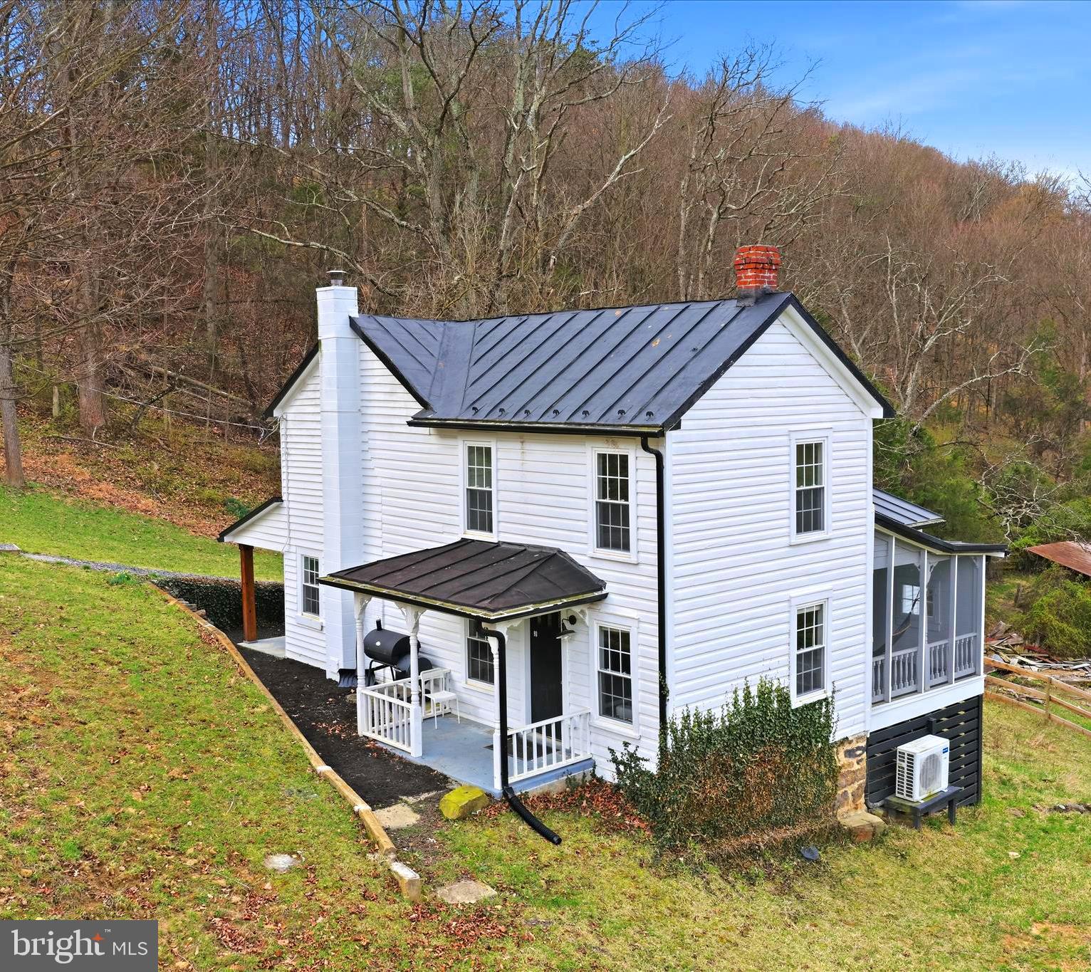a aerial view of a house with a yard balcony and furniture