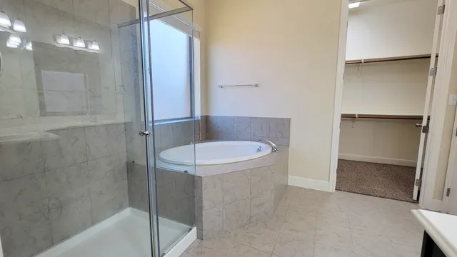 a bathroom with a granite countertop shower and a sink