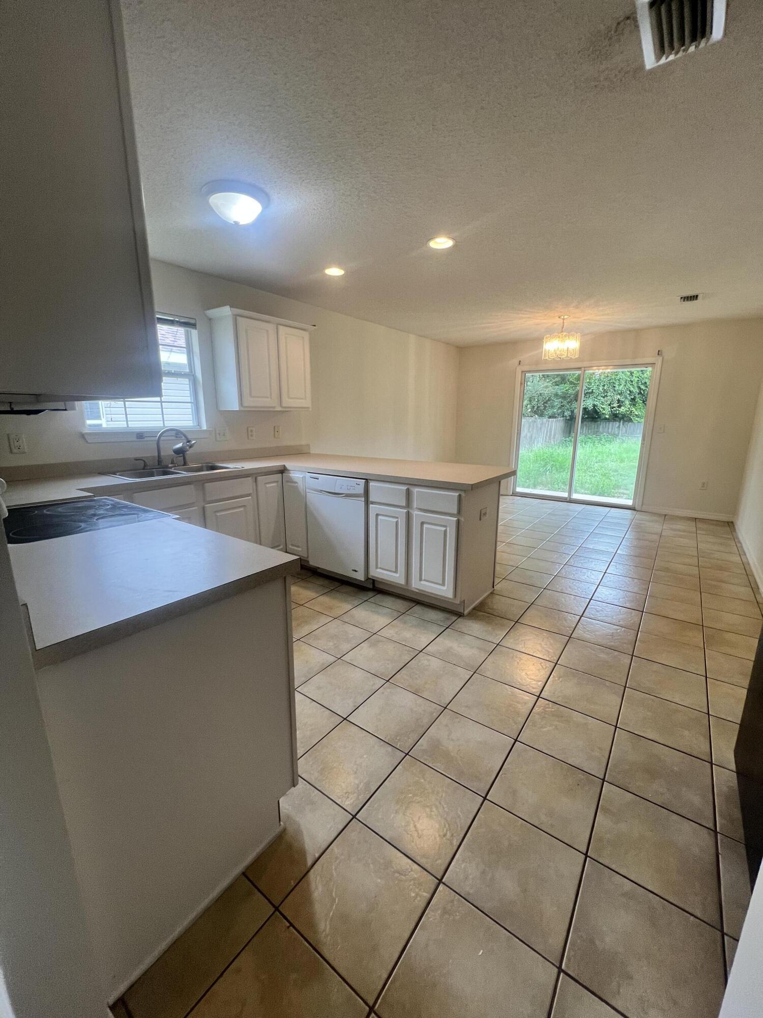 8 Howard Street Niceville, FL 32578 - Photo 13 of 22 a kitchen with stainless steel appliances a sink and a stove