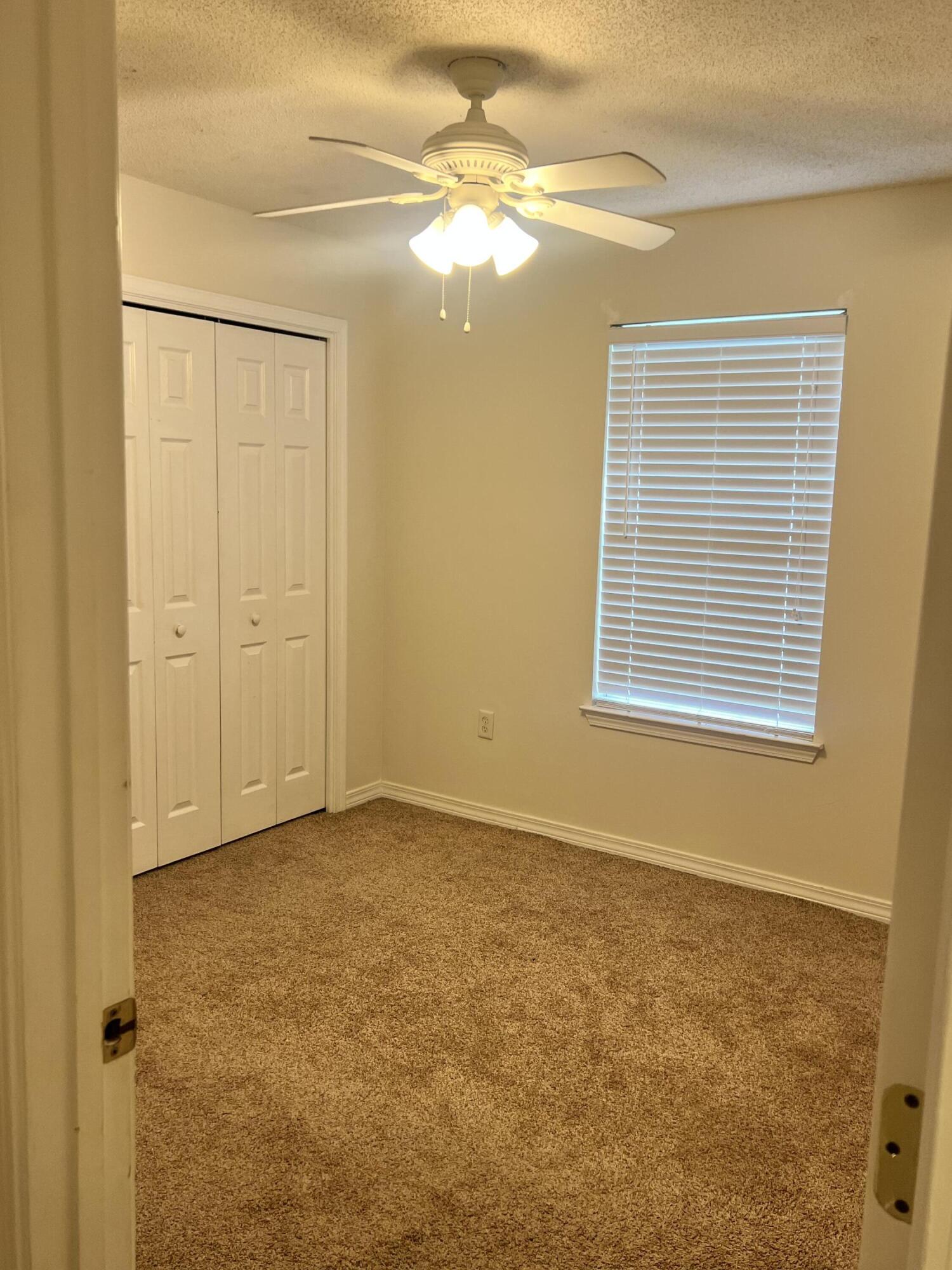 8 Howard Street Niceville, FL 32578 - Photo 16 of 22 a view of an empty room with window and chandelier fan