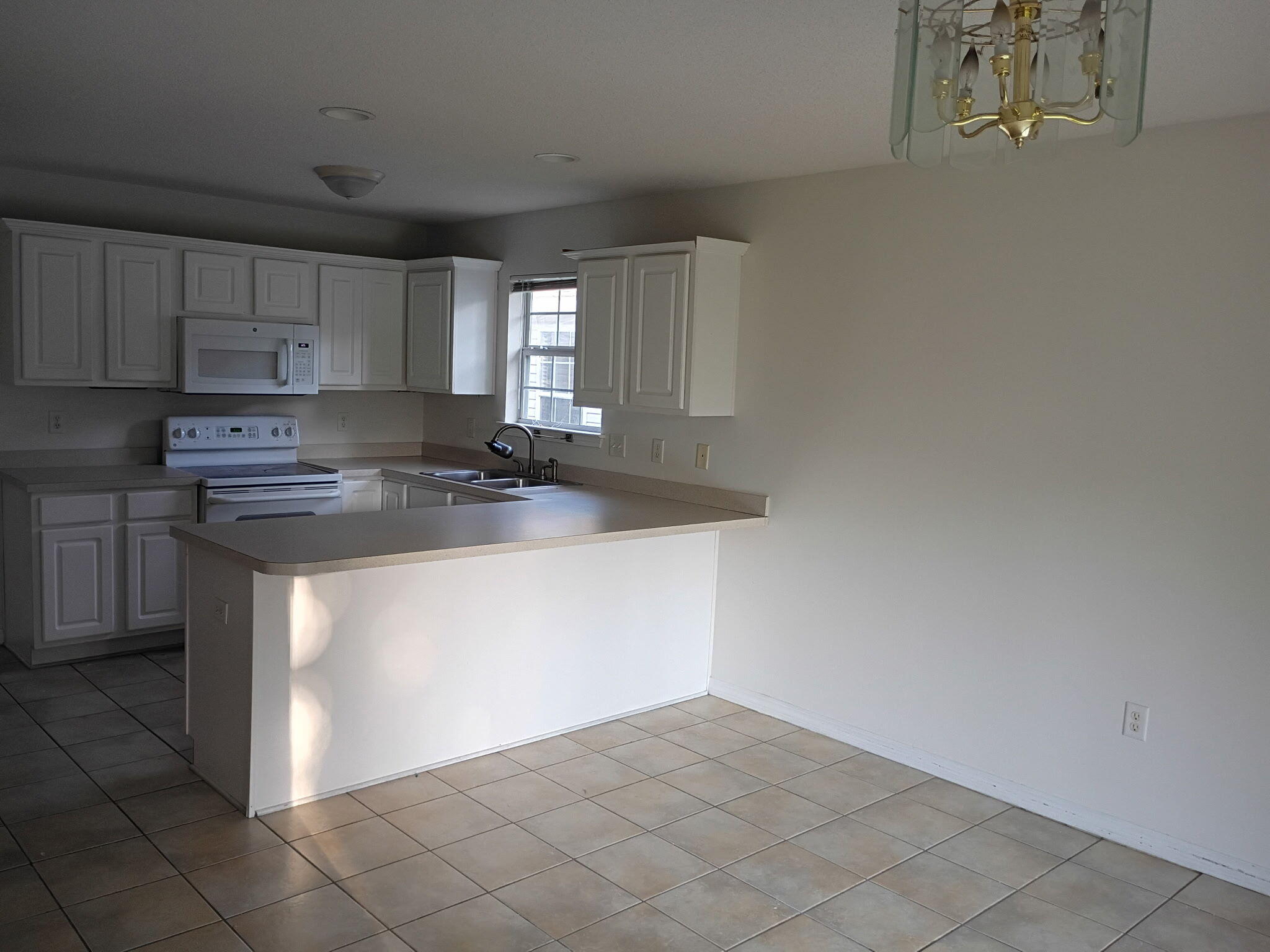 8 Howard Street Niceville, FL 32578 - Photo 2 of 22 a kitchen with stainless steel appliances granite countertop a sink a stove top oven a counter space and cabinets