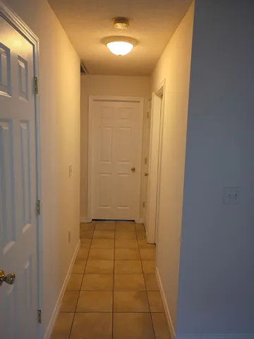 a view of a hallway with a door