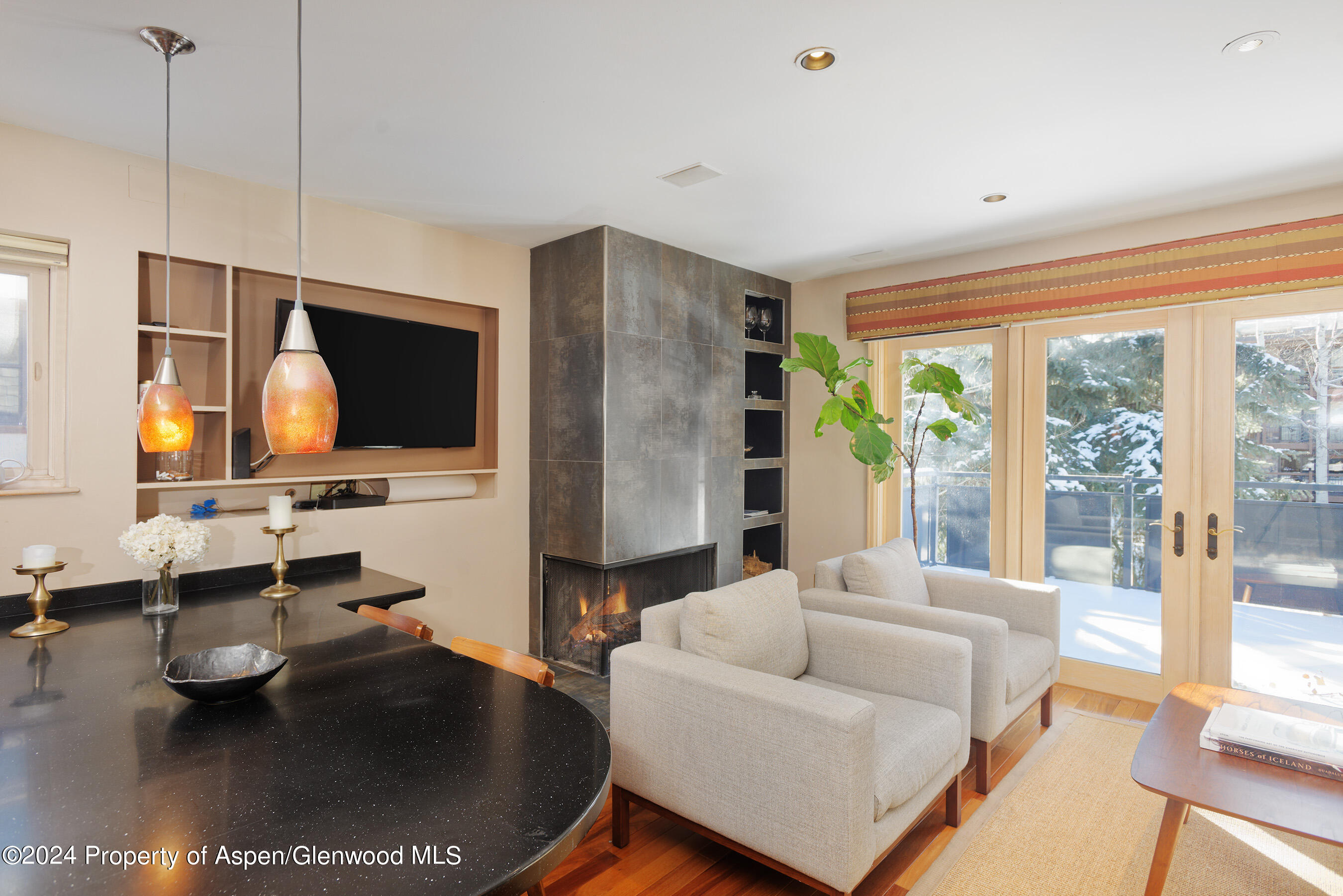 124 East Durant Avenue, Unit 1 Aspen, CO 81611 - Photo 3 of 11 a living room with fireplace furniture and a flat screen tv