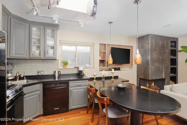 a kitchen with stainless steel appliances granite countertop a sink a stove and refrigerator