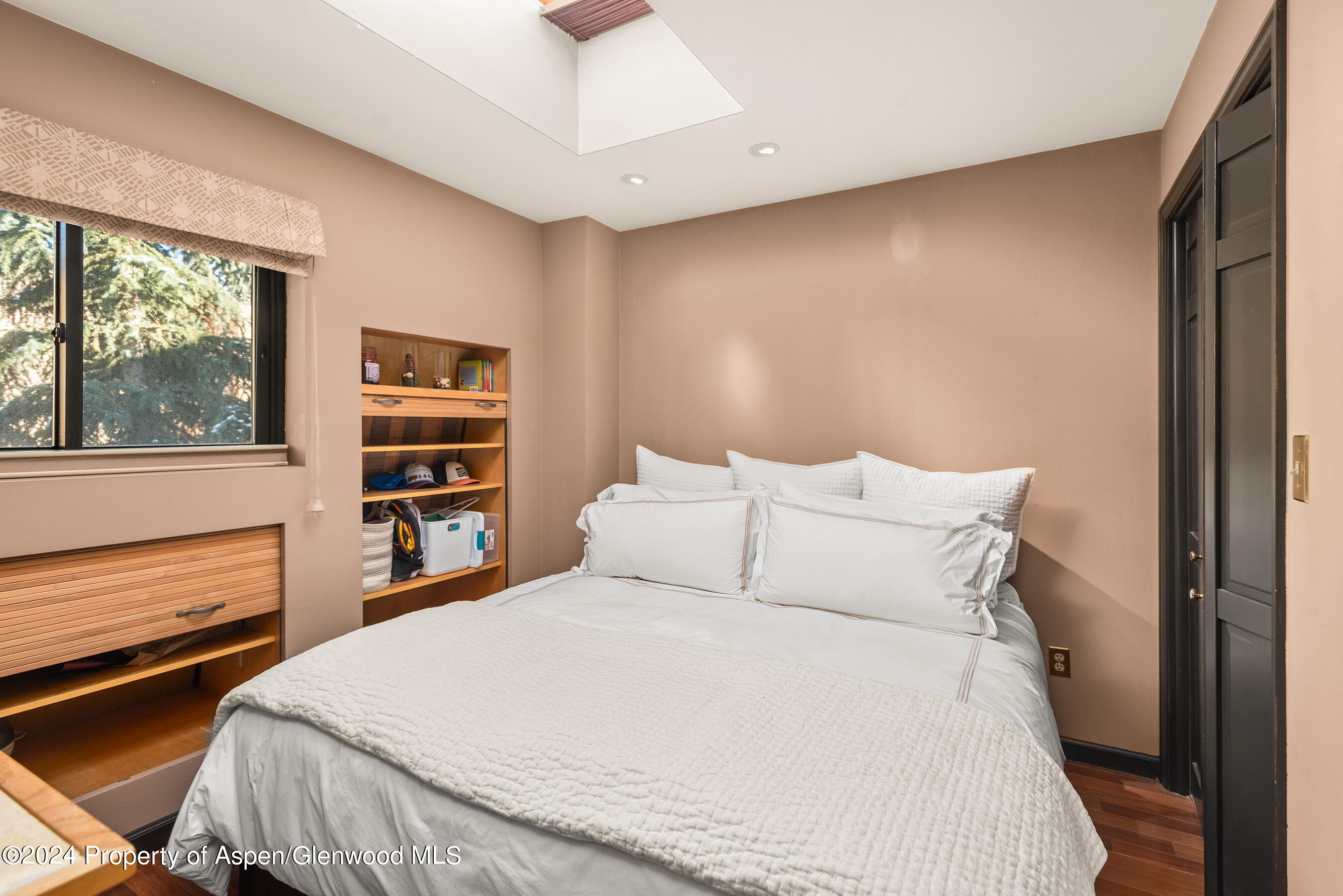 124 East Durant Avenue, Unit 1 Aspen, CO 81611 - Photo 7 of 11 a bedroom with a bed and a large window