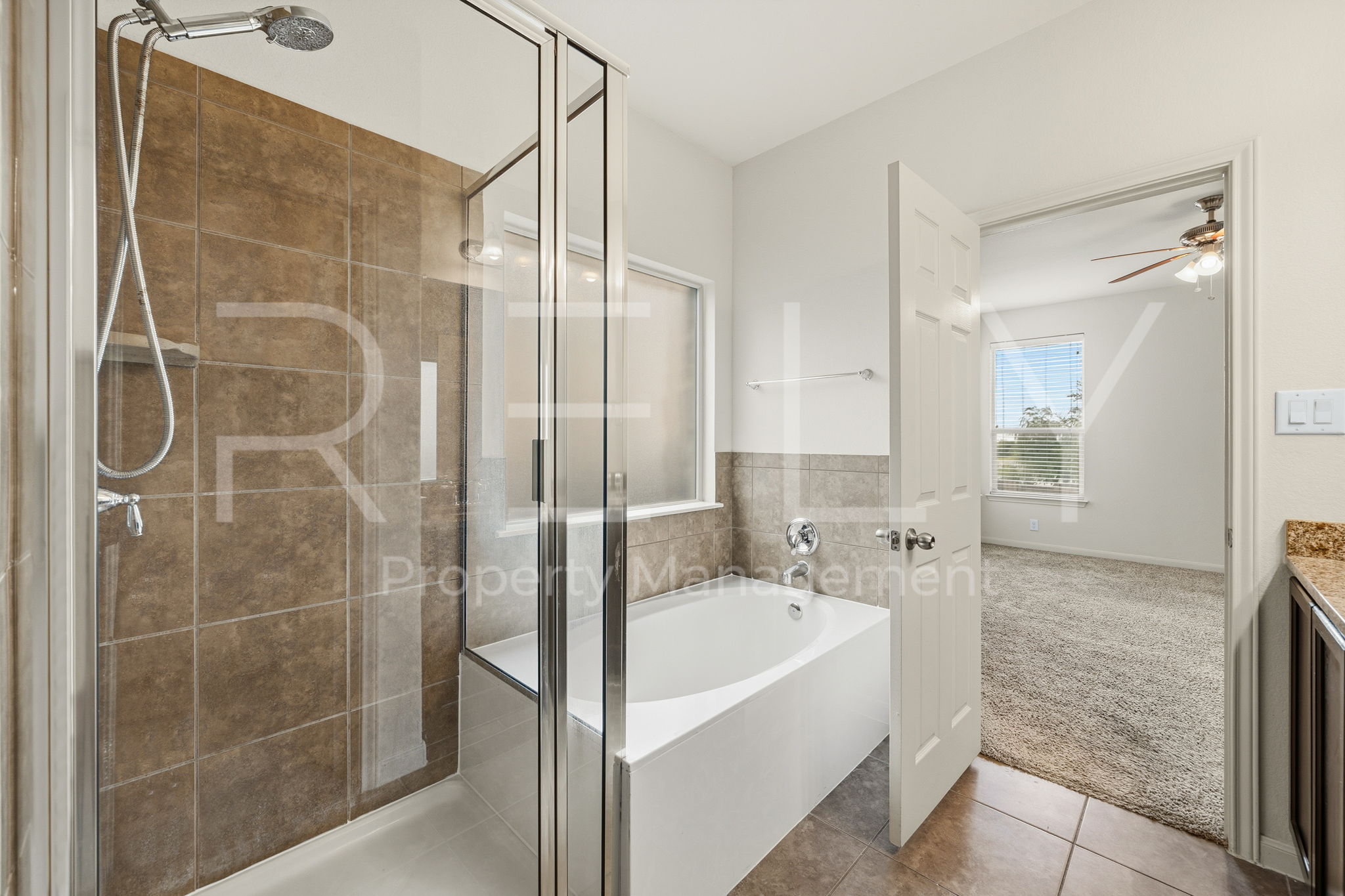 1405 Sunny Meadows Loop Georgetown, TX 78626 - Photo 20 of 40 Luxurious bathroom with a glass-enclosed shower and separate soaking tub.