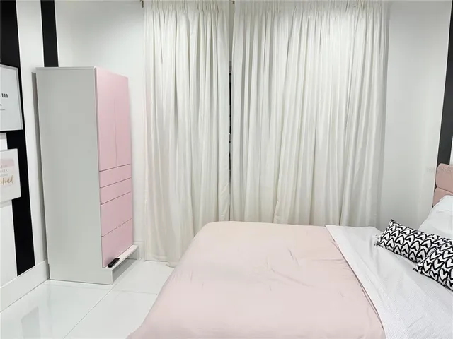 a bedroom with a bed and window