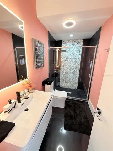 a spacious bedroom with a bed and a couch