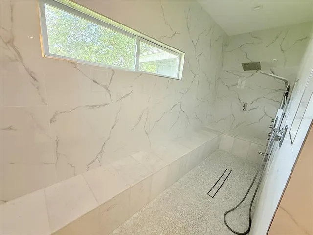 a view of a hallway with wooden floor and a living room