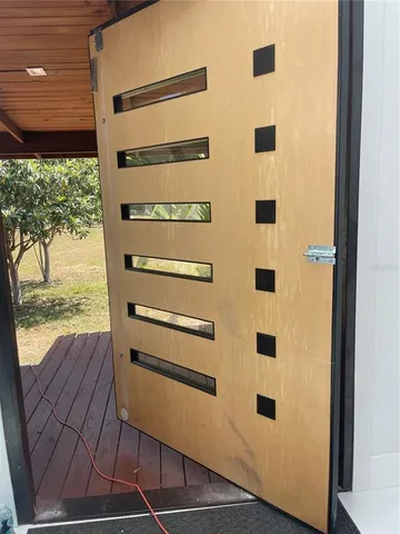 a kitchen that has a lot of white cabinets and stainless steel appliances