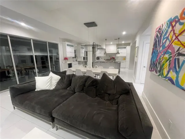 a bedroom with a white bed and white walls