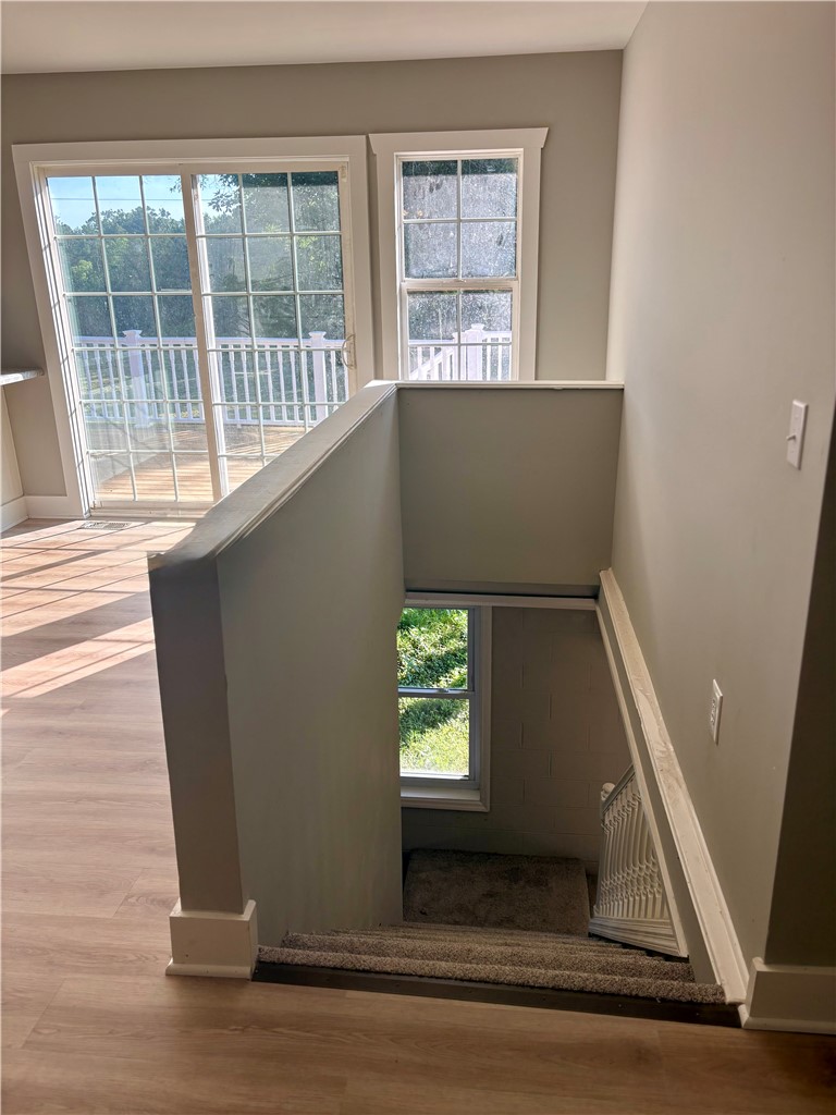 351 Randys Road Westminster, SC 29693 - Photo 10 of 30 Sun-filled interiors feature broad windows and seamless flooring, leading to a descending staircase.