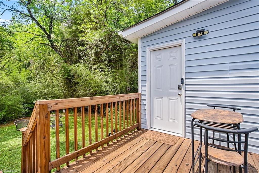 226 Friendly Avenue High Point, NC 27260 - Photo 22 of 38 The primary suite has its own exterior entrance with keypad access, offering true privacy and separate access from the rest of the home. Please note this suite is unpermitted and full seller disclosures are available.