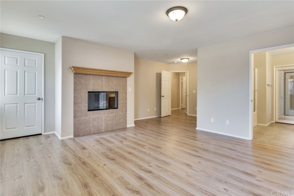 1555 Orange Avenue, Unit 401 Redlands, CA 92373 - Photo 14 of 21 an empty room with wooden floor and fireplace