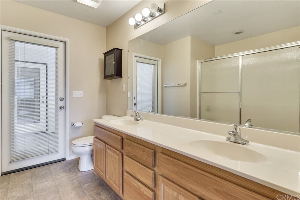 1555 Orange Avenue, Unit 401 Redlands, CA 92373 - Photo 15 of 21 a bathroom with a sink a toilet and shower