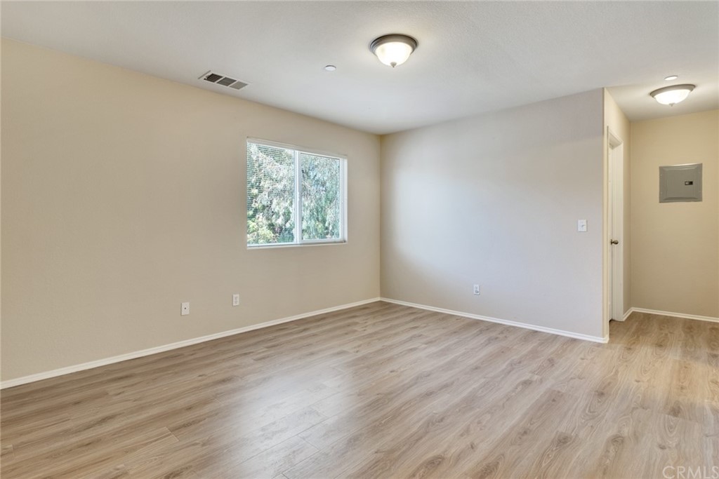 1555 Orange Avenue, Unit 401 Redlands, CA 92373 - Photo 16 of 21 an empty room with wooden floor and windows