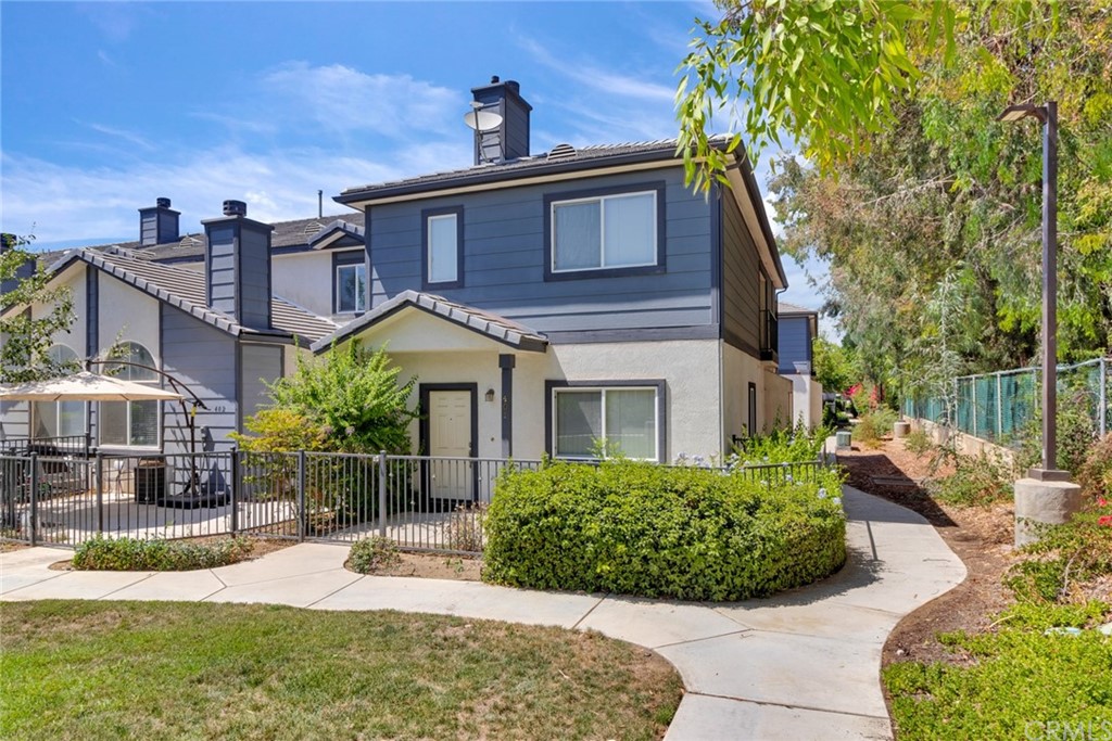 1555 Orange Avenue, Unit 401 Redlands, CA 92373 - Photo 2 of 21 a house view with a garden space