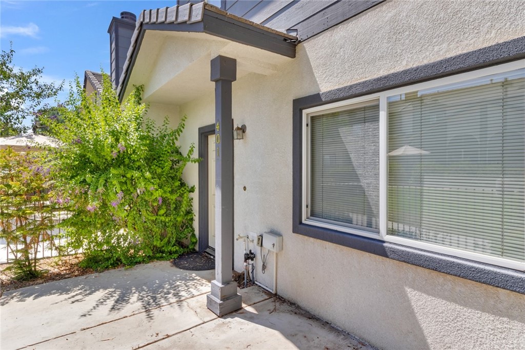 1555 Orange Avenue, Unit 401 Redlands, CA 92373 - Photo 3 of 21 a front view of a house with garden