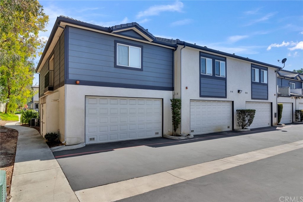 1555 Orange Avenue, Unit 401 Redlands, CA 92373 - Photo 4 of 21 a front view of a house with a garage