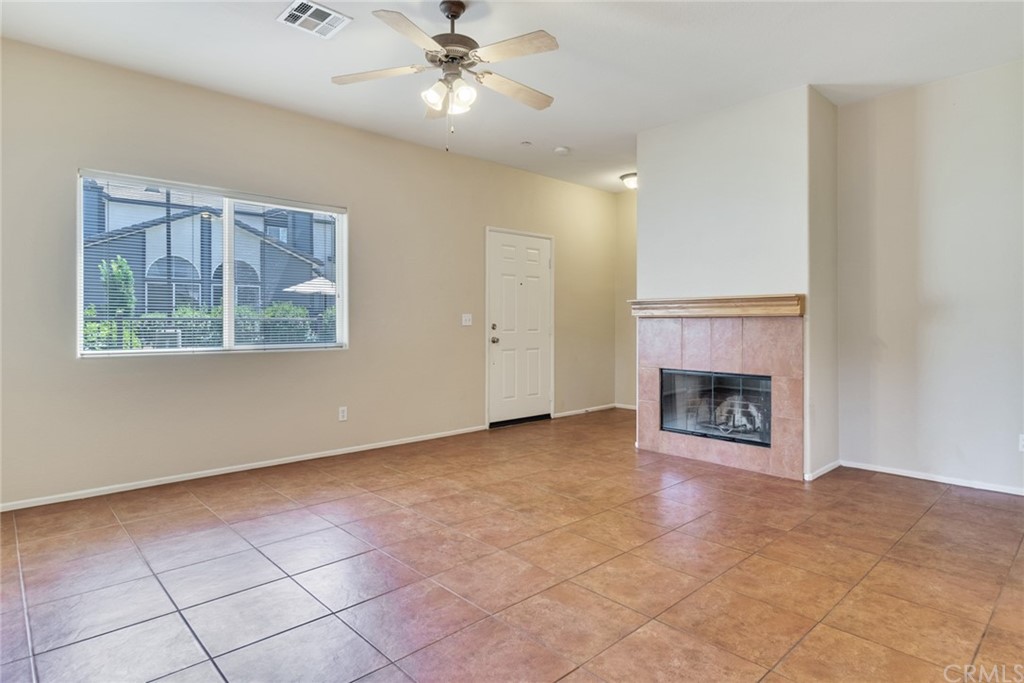 1555 Orange Avenue, Unit 401 Redlands, CA 92373 - Photo 6 of 21 a view of an empty room with a fireplace and a window