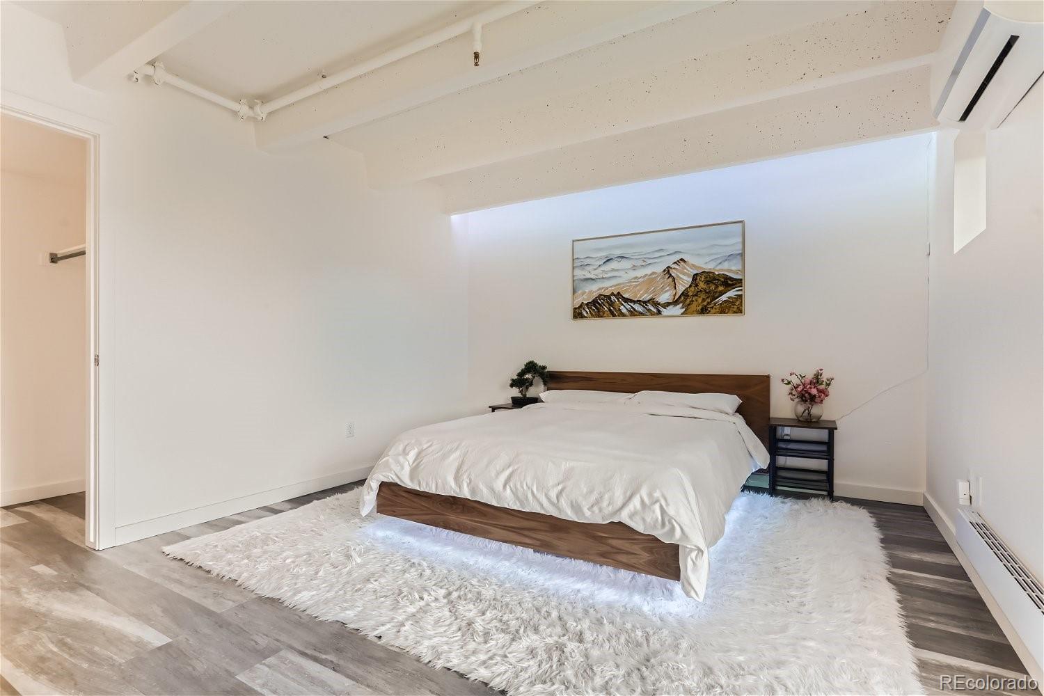 1495 Vrain Street, Unit 218 Denver, CO 80204 - Photo 3 of 5 a bedroom with a bed and a painting on the wall