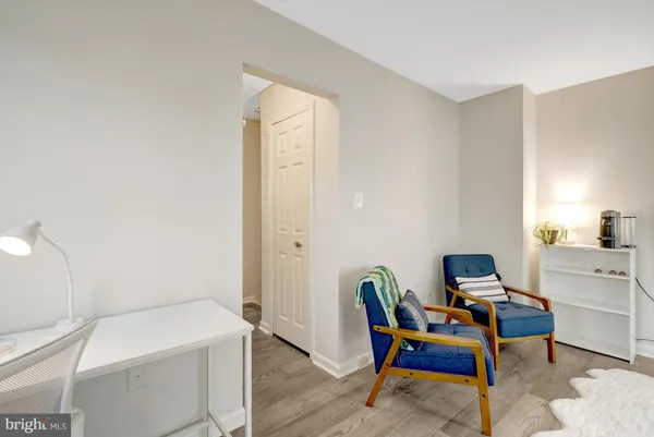 a view of staircase with white walls and door