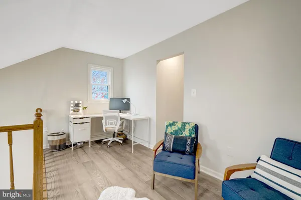 a living room with furniture and a ceiling fan