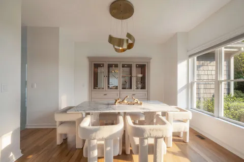 a view of a dining room with furniture wooden floor and chandelier