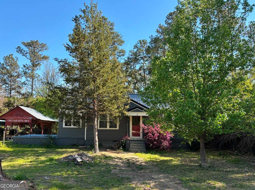 13162 Augusta Highway Sparta, GA 31087 - Photo 1 of 28 a view of a house with swimming pool and sitting area