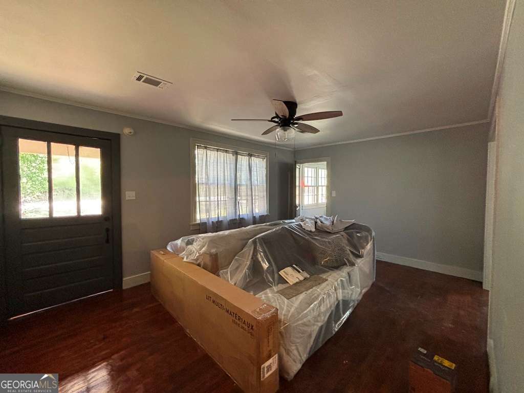 13162 Augusta Highway Sparta, GA 31087 - Photo 12 of 28 a bed sitting in a bedroom next to a window
