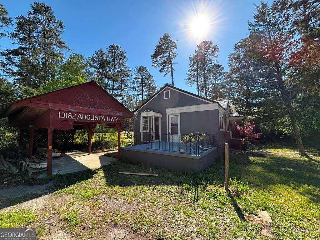 13162 Augusta Highway Sparta, GA 31087 - Photo 6 of 28 a front view of a house with garden