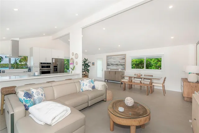 a living room with furniture a window and a table