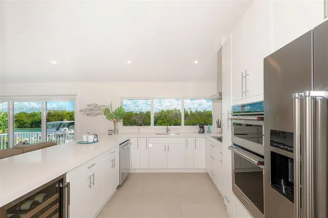 a kitchen with a refrigerator and a sink