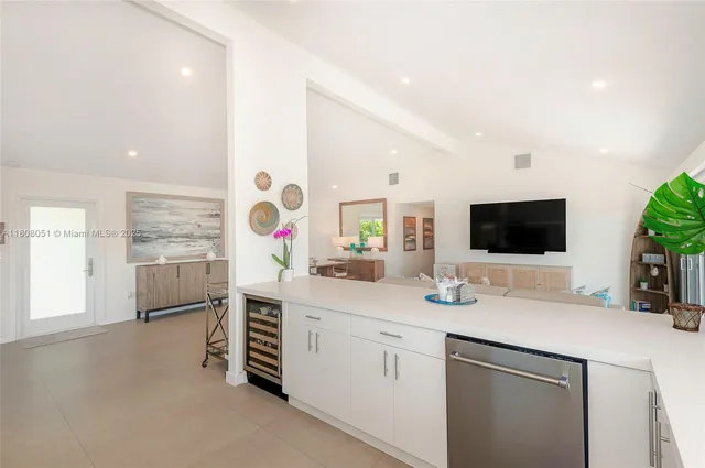 a kitchen with stainless steel appliances a sink and a refrigerator