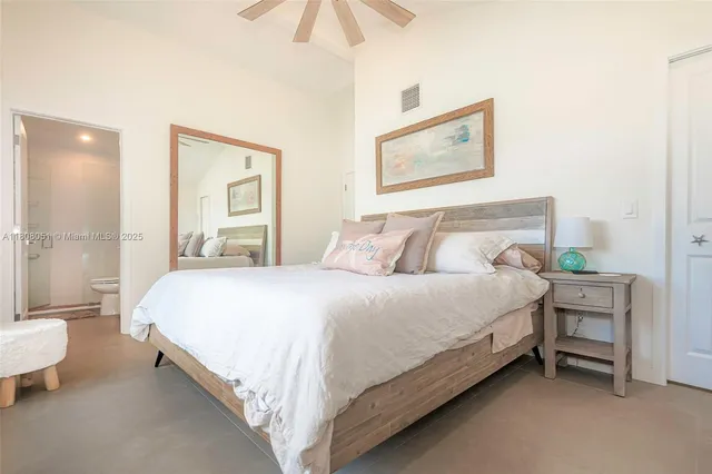 a bedroom with a bed and a painting on the wall