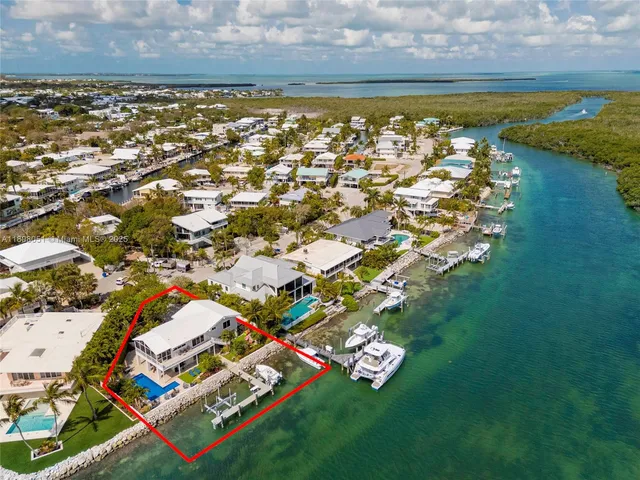 swimming pool with lawn chairs and a rug