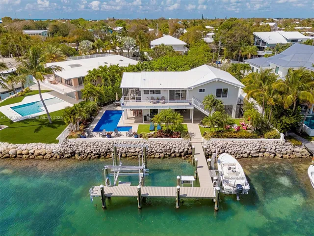 an aerial view of house with yard swimming pool and outdoor seating
