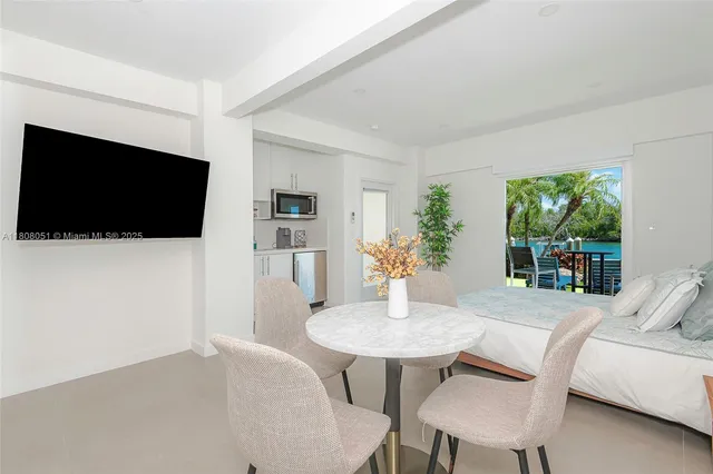 a view of a livingroom with furniture and a flat screen tv