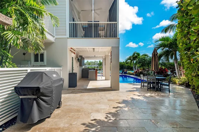 a view of a patio with table and chairs and potted plants