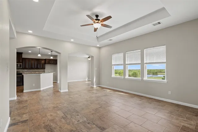a view of a livingroom with a ceiling fan and window