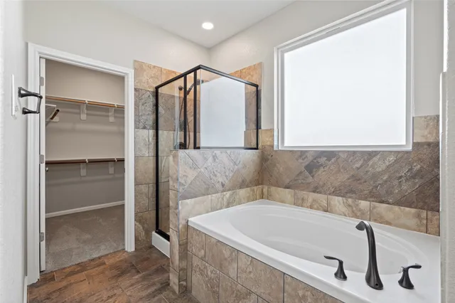 a bathroom with a tub and shower