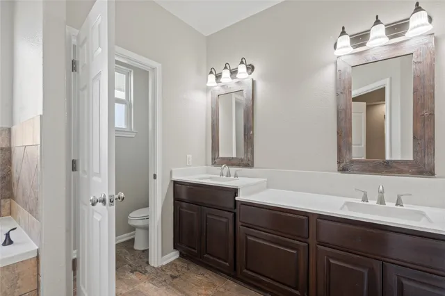 a bathroom with a double vanity sink mirror and double