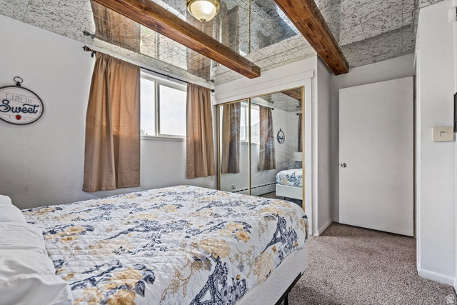 149 West 1600th Street South Mapleton, UT 84664 - Photo 16 of 44 Bedroom featuring beam ceiling, light carpet, a closet, and baseboard heating