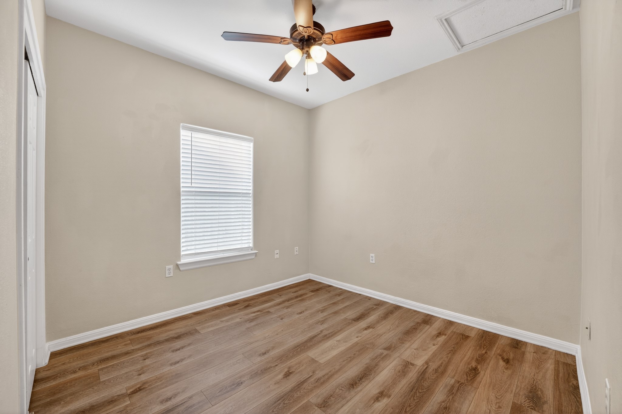5625 Signal Point Austin, TX 78724 - Photo 15 of 33 A well-lit bedroom features durable laminate flooring and a functional ceiling fan.